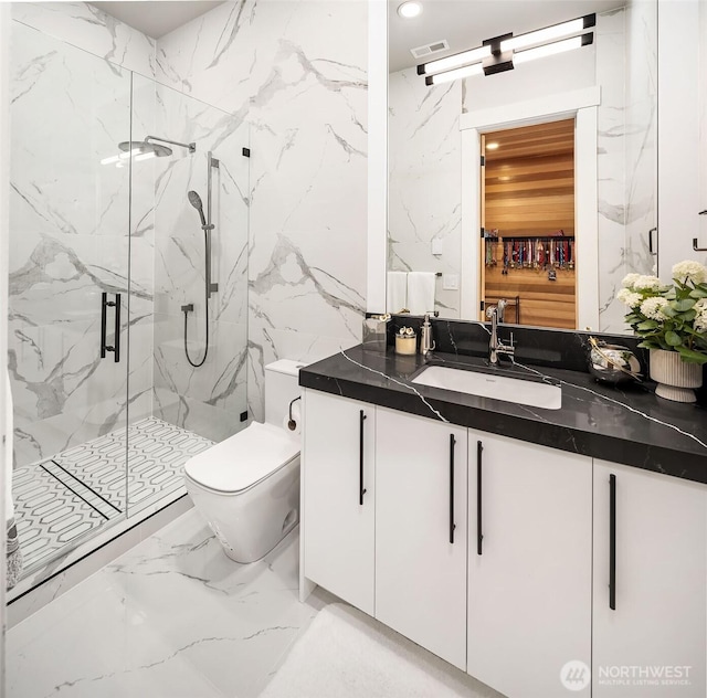 17281 SE 43rd St, Bellevue, WA 98006 - bathroom with marble tiled floors, a marble finish shower, vanity, toilet, and recessed lighting