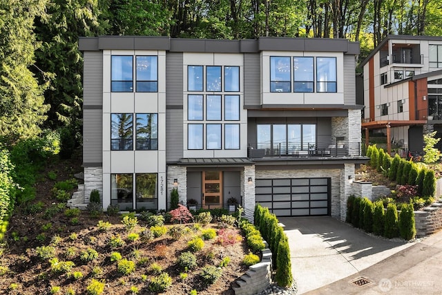 17281 SE 43rd St, Bellevue, WA 98006 - contemporary house with stone siding, driveway, and an attached garage