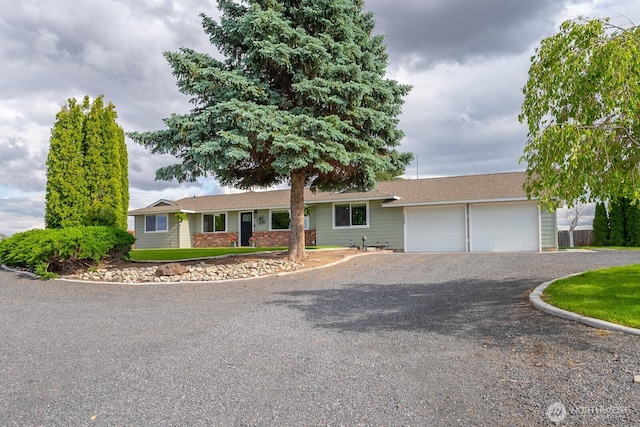 12009 NW Dodson Rd, Ephrata, WA 98823 - ranch-style home with a garage and gravel driveway