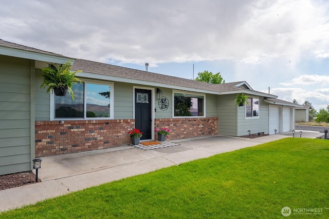 12009 NW Dodson Rd, Ephrata, WA 98823 - single story home featuring a front lawn, a garage, brick siding, and driveway