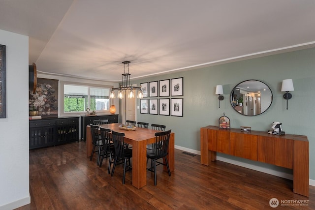 12009 NW Dodson Rd, Ephrata, WA 98823 - dining space featuring dark wood-style flooring, a chandelier, and baseboards