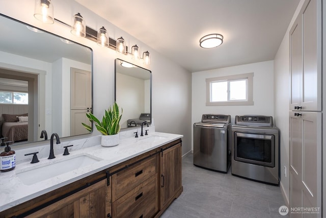 12009 NW Dodson Rd, Ephrata, WA 98823 - laundry area with washer and clothes dryer, healthy amount of natural light, and light tile patterned floors
