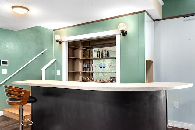 8827 Marlene Ct SW, Olympia, WA 98512 - indoor bar featuring dark wood-style floors, ornamental molding, and stairway