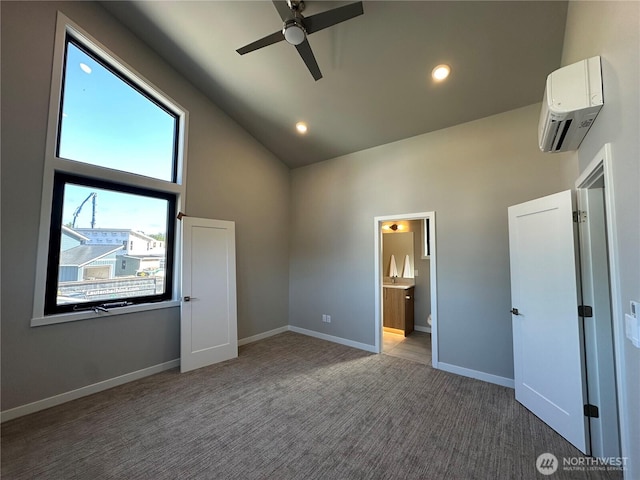 574 Creston Ct, Bellingham, WA 98226 - unfurnished bedroom featuring an AC wall unit, high vaulted ceiling, carpet, ensuite bathroom, and baseboards