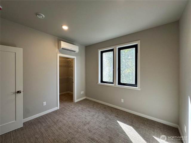 574 Creston Ct, Bellingham, WA 98226 - unfurnished bedroom featuring a wall mounted AC, a spacious closet, carpet, baseboards, and a closet