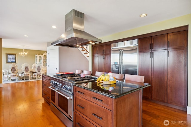 699 Lehman Dr, Camano Island, WA 98282 - kitchen featuring island range hood, premium appliances, a chandelier, a kitchen island, and dark stone counters