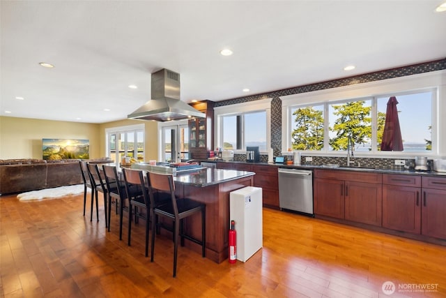 699 Lehman Dr, Camano Island, WA 98282 - kitchen featuring stainless steel dishwasher, island exhaust hood, light wood-style flooring, a kitchen island, and recessed lighting