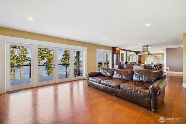 699 Lehman Dr, Camano Island, WA 98282 - living area featuring healthy amount of natural light, wood finished floors, recessed lighting, and french doors