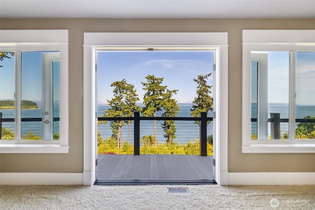 699 Lehman Dr, Camano Island, WA 98282 - doorway to outside featuring healthy amount of natural light and carpet
