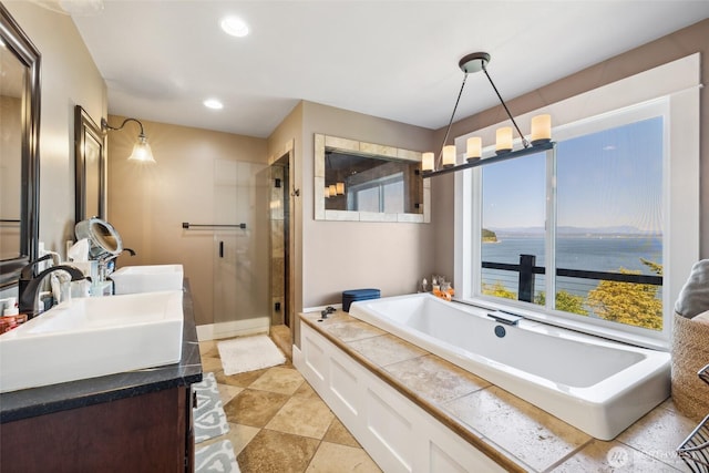 699 Lehman Dr, Camano Island, WA 98282 - full bathroom with a shower stall, a bath, double vanity, recessed lighting, and a water view
