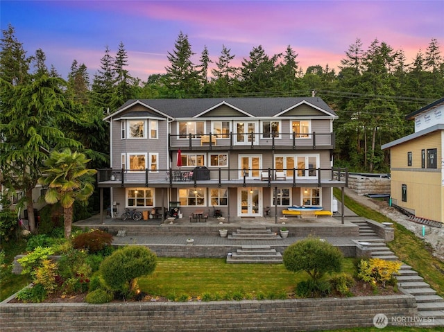 699 Lehman Dr, Camano Island, WA 98282 - back of house featuring french doors, a balcony, a patio, stairs, and a lawn