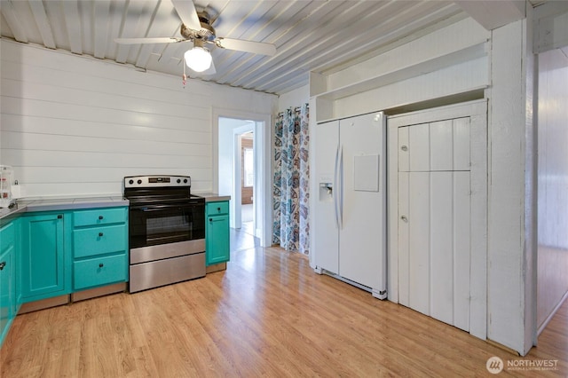 212 Hayes St, Hoquiam, WA 98550 - kitchen with electric stove, white refrigerator with ice dispenser, light wood-style flooring, and ceiling fan