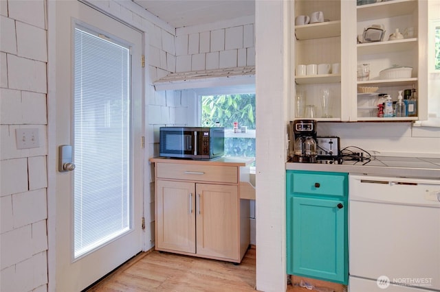 212 Hayes St, Hoquiam, WA 98550 - kitchen with stainless steel microwave, dishwasher, light wood-style floors, open shelves, and light countertops