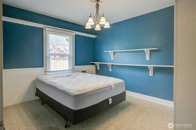 212 Hayes St, Hoquiam, WA 98550 - carpeted bedroom with a wainscoted wall and a chandelier