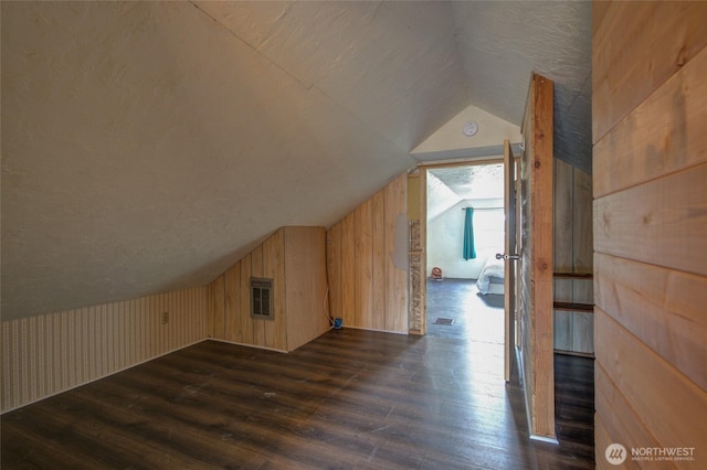 212 Hayes St, Hoquiam, WA 98550 - additional living space with dark wood finished floors, vaulted ceiling, and wood walls
