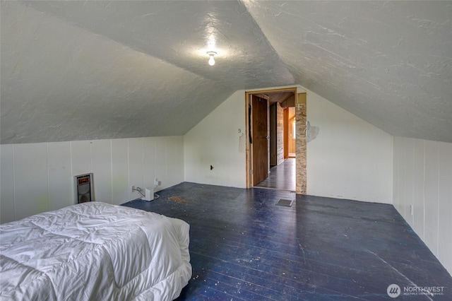212 Hayes St, Hoquiam, WA 98550 - bedroom with lofted ceiling, wood finished floors, and a textured ceiling