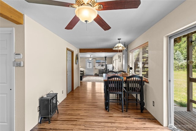 51 Deer Meadow Ln, Naches, WA 98937 - dining space with a ceiling fan, a wood stove, wood finished floors, and beamed ceiling