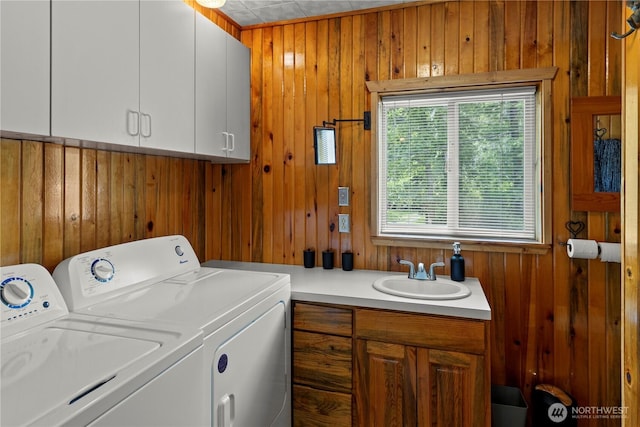 51 Deer Meadow Ln, Naches, WA 98937 - washroom featuring cabinet space, wood walls, and washing machine and clothes dryer