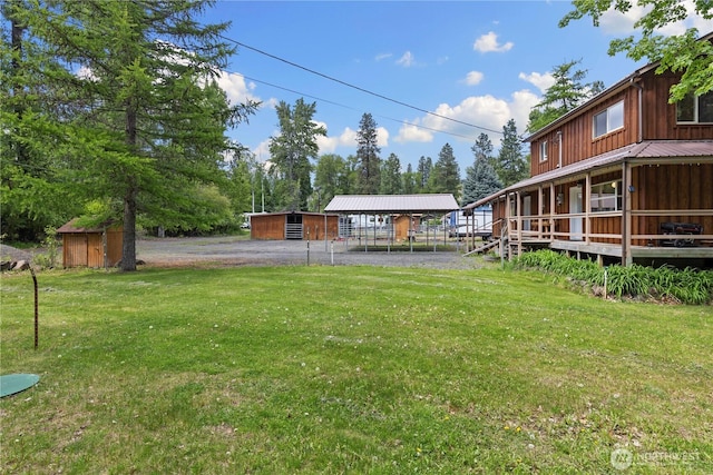 51 Deer Meadow Ln, Naches, WA 98937 - view of green lawn featuring a carport, an outbuilding, and gravel driveway