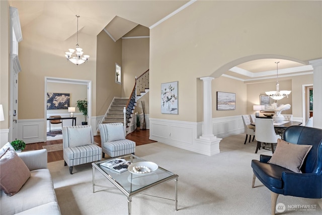25939 SE 22nd Pl, Sammamish, WA 98075 - living area featuring decorative columns, a chandelier, a decorative wall, arched walkways, and crown molding