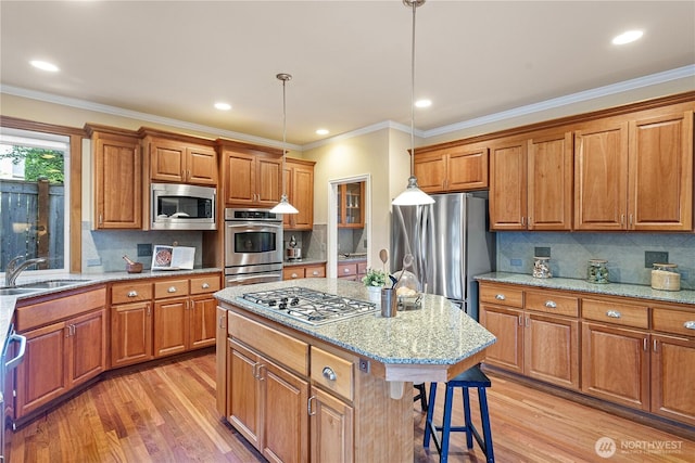 25939 SE 22nd Pl, Sammamish, WA 98075 - kitchen featuring stainless steel appliances, a sink, light wood-type flooring, brown cabinets, and ornamental molding