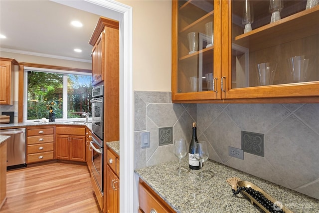 25939 SE 22nd Pl, Sammamish, WA 98075 - kitchen with dishwasher, ornamental molding, light stone counters, light wood-style floors, and glass insert cabinets