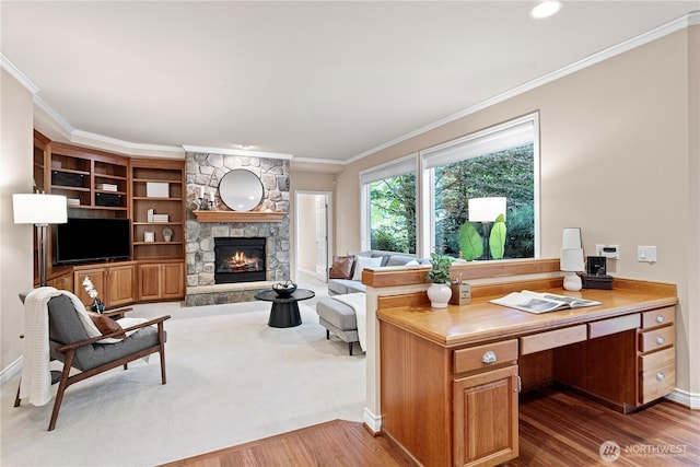 25939 SE 22nd Pl, Sammamish, WA 98075 - home office featuring wood finished floors, ornamental molding, a stone fireplace, baseboards, and built in desk