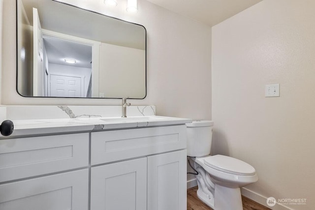 8823 Holly Dr Unit G205, Everett, WA 98208 - half bath with wood finished floors, baseboards, vanity, and toilet