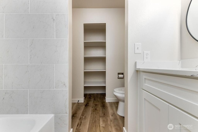 8823 Holly Dr Unit G205, Everett, WA 98208 - full bath featuring wood finished floors, vanity, toilet, and a bathtub
