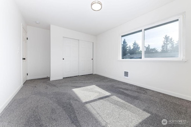 8823 Holly Dr Unit G205, Everett, WA 98208 - unfurnished bedroom with carpet, baseboards, and a closet