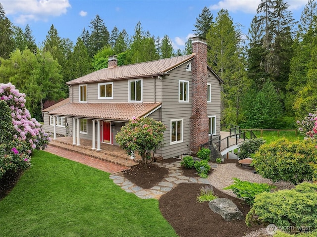 12653 Avondale Rd NE, Redmond, WA 98052 - view of front of home with a chimney, a tiled roof, a front lawn, and covered porch