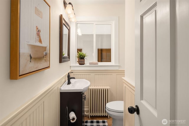 12653 Avondale Rd NE, Redmond, WA 98052 - bathroom featuring radiator, a decorative wall, wainscoting, vanity, and toilet