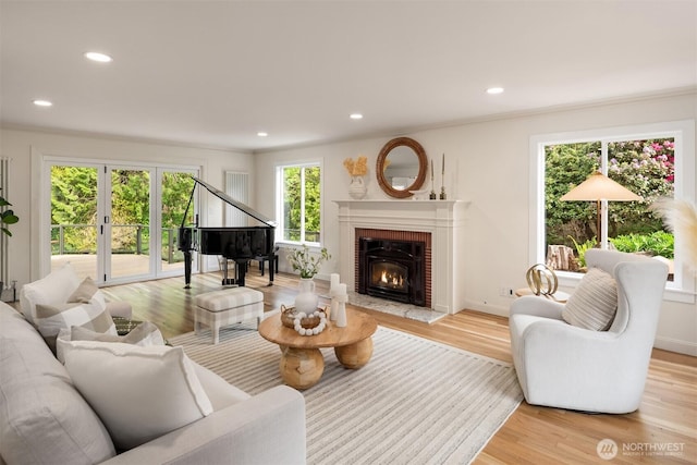 12653 Avondale Rd NE, Redmond, WA 98052 - living room with light wood finished floors, recessed lighting, a brick fireplace, french doors, and baseboards