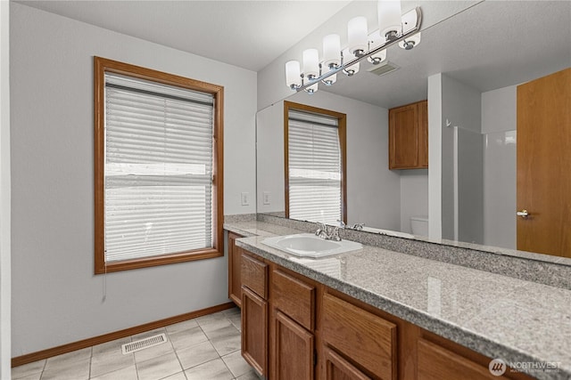 3726 SW 313th St, Federal Way, WA 98023 - bathroom with vanity, toilet, baseboards, tile patterned flooring, and a shower