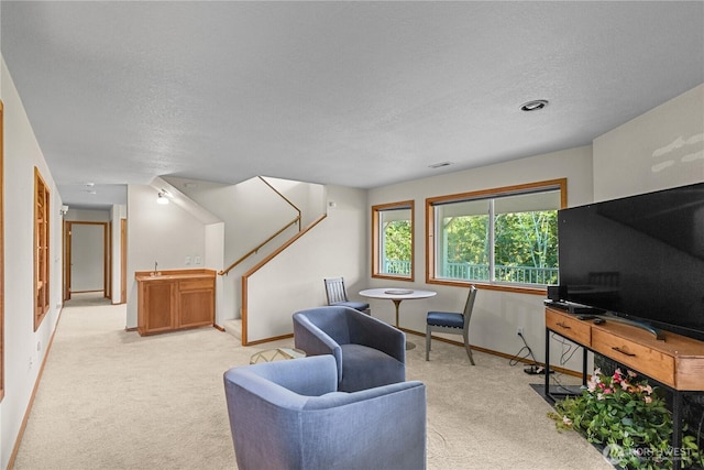 3726 SW 313th St, Federal Way, WA 98023 - living area featuring light carpet, baseboards, stairs, and a textured ceiling