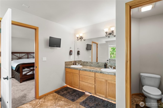 2903 96th St SE, Everett, WA 98208 - full bathroom with double vanity, ensuite bathroom, toilet, and baseboards