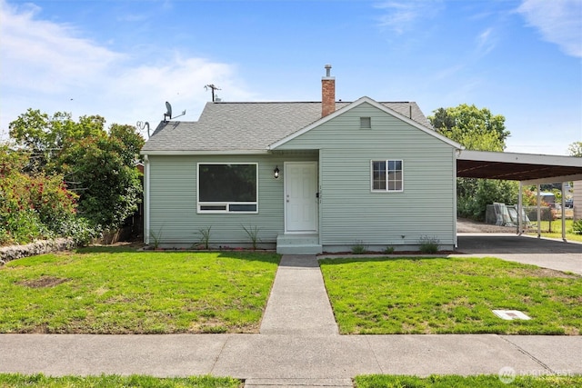 1221 Tillamook St, Walla Walla, WA 99362 - bungalow featuring an attached carport, roof with shingles, a chimney, and driveway
