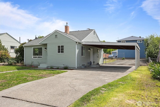 1221 Tillamook St, Walla Walla, WA 99362 - view of front of house with driveway, a chimney, an attached carport, and roof with shingles