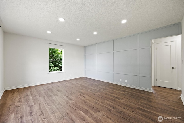 1221 Tillamook St, Walla Walla, WA 99362 - unfurnished room with wood finished floors, a textured ceiling, a decorative wall, recessed lighting, and baseboards