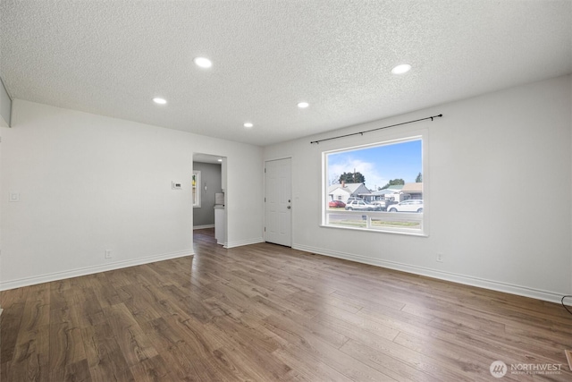 1221 Tillamook St, Walla Walla, WA 99362 - unfurnished living room featuring a textured ceiling, wood finished floors, recessed lighting, and baseboards