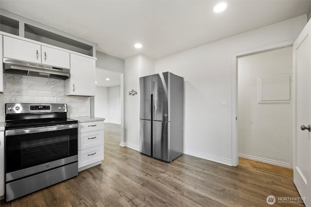 1221 Tillamook St, Walla Walla, WA 99362 - kitchen featuring appliances with stainless steel finishes, under cabinet range hood, white cabinets, tasteful backsplash, and light countertops