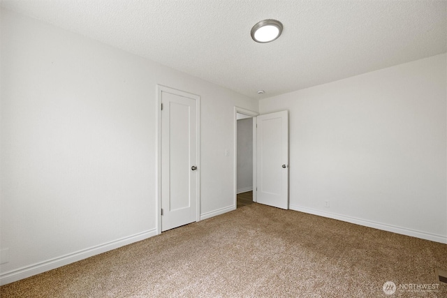 1221 Tillamook St, Walla Walla, WA 99362 - unfurnished bedroom with carpet floors, baseboards, and a textured ceiling