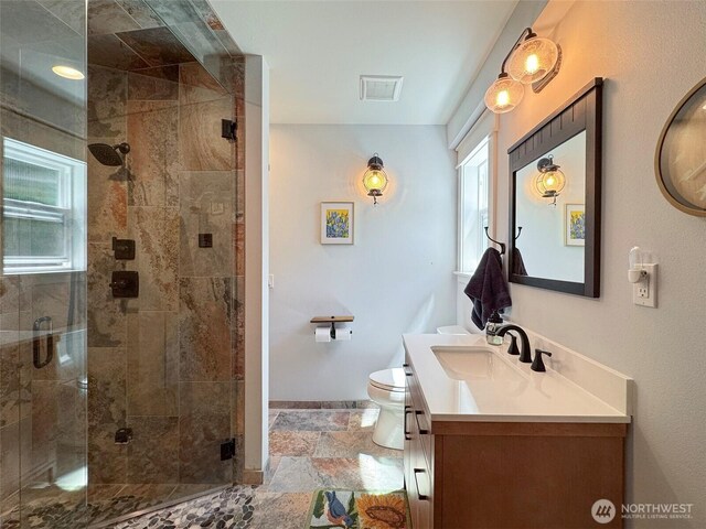 1068 Happy Valley Rd, Sequim, WA 98382 - bathroom with vanity, toilet, a shower stall, baseboards, and stone finish floors