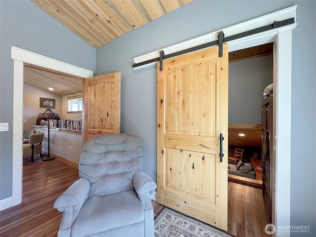 1068 Happy Valley Rd, Sequim, WA 98382 - sitting room featuring lofted ceiling, wood finished floors, a barn door, and recessed lighting