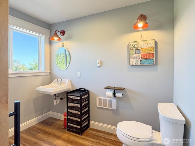 1068 Happy Valley Rd, Sequim, WA 98382 - half bath with toilet, wood finished floors, baseboards, and a sink