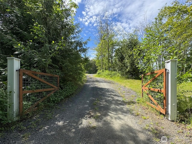 1068 Happy Valley Rd, Sequim, WA 98382 - view of dirt / gravel road with a gate and a gated entry