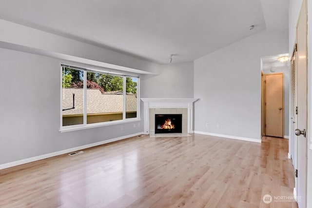10903 Paine Field Way, Everett, WA 98204 - unfurnished living room featuring a fireplace, light wood-type flooring, and baseboards