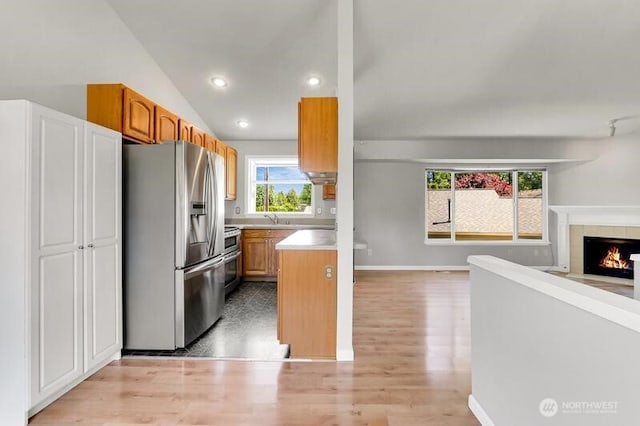 10903 Paine Field Way, Everett, WA 98204 - kitchen with stainless steel appliances, open floor plan, light wood finished floors, brown cabinets, and recessed lighting