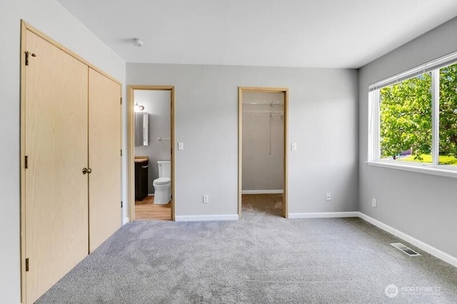 10903 Paine Field Way, Everett, WA 98204 - unfurnished bedroom featuring light carpet, connected bathroom, a closet, and baseboards