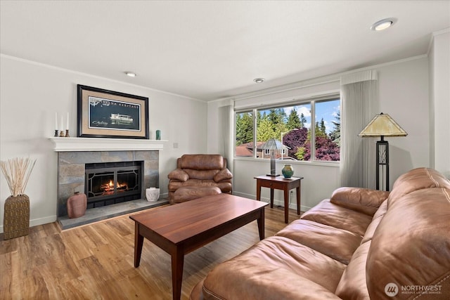 9 199th Pl SE, Bothell, WA 98012 - living room with ornamental molding, wood finished floors, a tiled fireplace, baseboards, and recessed lighting